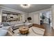 Beautiful living room features a comfortable sectional sofa, wood floors, and an open layout leading to the kitchen and stairway at 4335 Bellview Ln, Duluth, GA 30097