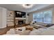 Cozy living room featuring a stone fireplace, built-in shelving, and a plush sectional sofa near bright windows at 4335 Bellview Ln, Duluth, GA 30097