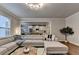 Bright living room boasts a large sectional sofa, stylish lighting, and an open floor plan to the modern kitchen at 4335 Bellview Ln, Duluth, GA 30097