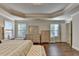 Bright and inviting main bedroom with tray ceiling, a bed and lots of dresser storage at 4335 Bellview Ln, Duluth, GA 30097