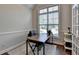 Office space with vaulted ceilings, large window and dark wood desk with chair at 4335 Bellview Ln, Duluth, GA 30097