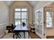 Office space with vaulted ceilings, large window and dark wood desk with chair at 4335 Bellview Ln, Duluth, GA 30097