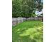Spacious backyard with lush green grass and mature trees, perfect for outdoor activities at 979 Simonton Glen Dr, Lawrenceville, GA 30045