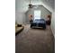 Cozy bedroom featuring vaulted ceilings, a ceiling fan, and a comfortable bed with bedside tables and a couch at 979 Simonton Glen Dr, Lawrenceville, GA 30045