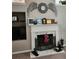 Stylish fireplace with marble surround, decorative mantel, and intricate metal grate, creating a cozy focal point at 979 Simonton Glen Dr, Lawrenceville, GA 30045