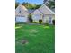 Landscaped front yard featuring a brick border, a well-manicured lawn and a beige brick house at 979 Simonton Glen Dr, Lawrenceville, GA 30045