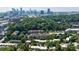 An aerial shows a neighborhood with apartments and townhomes near a city skyline at 101 Ardmore Nw Pl # 3, Atlanta, GA 30309