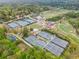 This aerial shot showcases the tennis courts and clubhouse nestled within a tree-lined community at 101 Ardmore Nw Pl # 3, Atlanta, GA 30309
