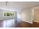 Sunlit living room with large window and hardwood floors, adjacent to doorway at 101 Ardmore Nw Pl # 3, Atlanta, GA 30309
