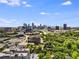Sweeping skyline views capture a mix of modern towers and lush green canopy with sunny sky at 101 Ardmore Nw Pl # 3, Atlanta, GA 30309