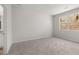 Neutral bedroom with carpet, large window, and closet door, offering a serene retreat at 114 Crooked Lake Park, Villa Rica, GA 30180