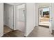 Light-filled foyer with hardwood floors, leading to a bedroom and showing a view of the front yard at 114 Crooked Lake Park, Villa Rica, GA 30180