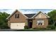 Charming brick home with attached garage, lovely landscaping, and classic architectural details at 114 Crooked Lake Park, Villa Rica, GA 30180
