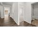 Bright hallway with hardwood flooring leading to bedrooms and open-concept living area at 114 Crooked Lake Park, Villa Rica, GA 30180