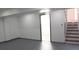 Finished basement features freshly painted walls, new flooring, and a staircase leading to the upper level at 1417 Pineglen Dr, Riverdale, GA 30296