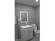 Well-lit bathroom featuring a modern white vanity, a mirror, and a toilet at 1417 Pineglen Dr, Riverdale, GA 30296