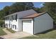 Charming two-story home featuring white painted brick, siding, a two-car garage, and a well-manicured lawn at 1417 Pineglen Dr, Riverdale, GA 30296