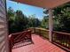 Cozy red wood deck overlooking the backyard with a railing, perfect for outdoor relaxation and entertaining at 2550 Lynshire Ln, Snellville, GA 30078
