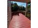 Cozy red wood deck overlooking the backyard with a railing, perfect for outdoor relaxation and entertaining at 2550 Lynshire Ln, Snellville, GA 30078
