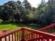 View of the backyard showing lawn, playset, and mature trees at 2550 Lynshire Ln, Snellville, GA 30078