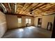 Spacious unfinished basement with concrete floor, ceiling fan, and natural light from two windows at 2550 Lynshire Ln, Snellville, GA 30078