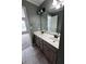 Bathroom featuring double sink vanity with grey cabinets, neutral countertop and large mirror at 2550 Lynshire Ln, Snellville, GA 30078
