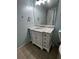 Bathroom featuring vanity with marble countertop, tile flooring, mirror, and natural light at 2550 Lynshire Ln, Snellville, GA 30078
