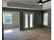 Spacious carpeted main bedroom with ceiling fan, large windows, and access to an additional room and outdoor deck at 2550 Lynshire Ln, Snellville, GA 30078