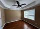 Bedroom featuring wood flooring, a ceiling fan, and window providing natural light at 2550 Lynshire Ln, Snellville, GA 30078