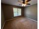 Bedroom with a ceiling fan and a large window providing natural light at 2550 Lynshire Ln, Snellville, GA 30078