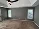 This is an image of a carpeted main bedroom that features a ceiling fan and two large windows at 2550 Lynshire Ln, Snellville, GA 30078
