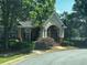 Charming clubhouse with brick facade, manicured landscaping, and covered entryway for community gatherings at 2550 Lynshire Ln, Snellville, GA 30078