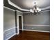 Formal dining room with hardwood flooring and classic lighting fixture at 2550 Lynshire Ln, Snellville, GA 30078