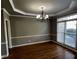 Dining room with hardwood floors, elegant chandelier, and natural light at 2550 Lynshire Ln, Snellville, GA 30078