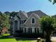 Beautiful brick home with a manicured lawn, showcasing classic architectural details and mature trees at 2550 Lynshire Ln, Snellville, GA 30078