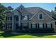 Charming two-story brick home with black shutters and well-maintained landscaping, perfect for curb appeal at 2550 Lynshire Ln, Snellville, GA 30078