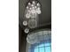 Gorgeous foyer with a crystal chandelier fixture and large window, making an eye-catching statement at 2550 Lynshire Ln, Snellville, GA 30078