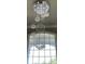 Stunning foyer featuring a modern, tiered chandelier and an expansive arched window, creating a grand entrance at 2550 Lynshire Ln, Snellville, GA 30078