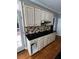 Kitchen featuring traditional cabinets, black countertops, and a stylish brick backsplash at 2550 Lynshire Ln, Snellville, GA 30078