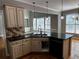 Open concept kitchen with black countertops, stainless steel sink, traditional cabinetry at 2550 Lynshire Ln, Snellville, GA 30078
