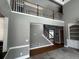 Open-concept living room featuring hardwood floors and high ceilings at 2550 Lynshire Ln, Snellville, GA 30078