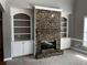 Inviting living room with a stone fireplace, custom built-in shelving, and elegant trim, great for entertaining at 2550 Lynshire Ln, Snellville, GA 30078