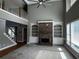Spacious living room featuring a stone fireplace, built-in shelves, and abundant natural light at 2550 Lynshire Ln, Snellville, GA 30078