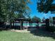 Community pool area features a gazebo, lounge seating, and secured fence at 2550 Lynshire Ln, Snellville, GA 30078