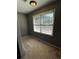 Small carpeted room with one window and gray walls. The room needs some light at 2550 Lynshire Ln, Snellville, GA 30078