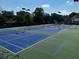 Multiple well-maintained tennis courts with nets and lighting in the Montclair community at 2550 Lynshire Ln, Snellville, GA 30078
