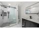 Modern bathroom with a glass shower and black fixtures, with a dark vanity at 2775 Harper Ferry Dr, Lawrenceville, GA 30044