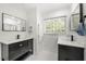 Bright bathroom with double vanity, black fixtures, and large window with a view at 2775 Harper Ferry Dr, Lawrenceville, GA 30044