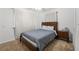 Bedroom with carpet, wooden bed frame, and window with curtains letting in light at 2775 Harper Ferry Dr, Lawrenceville, GA 30044