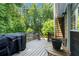 Home's deck area features a cooking area and a table with chairs at 2775 Harper Ferry Dr, Lawrenceville, GA 30044
